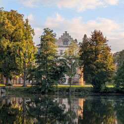 Das Schloss spiegelt sich im See im Park Reinhardsbrunn